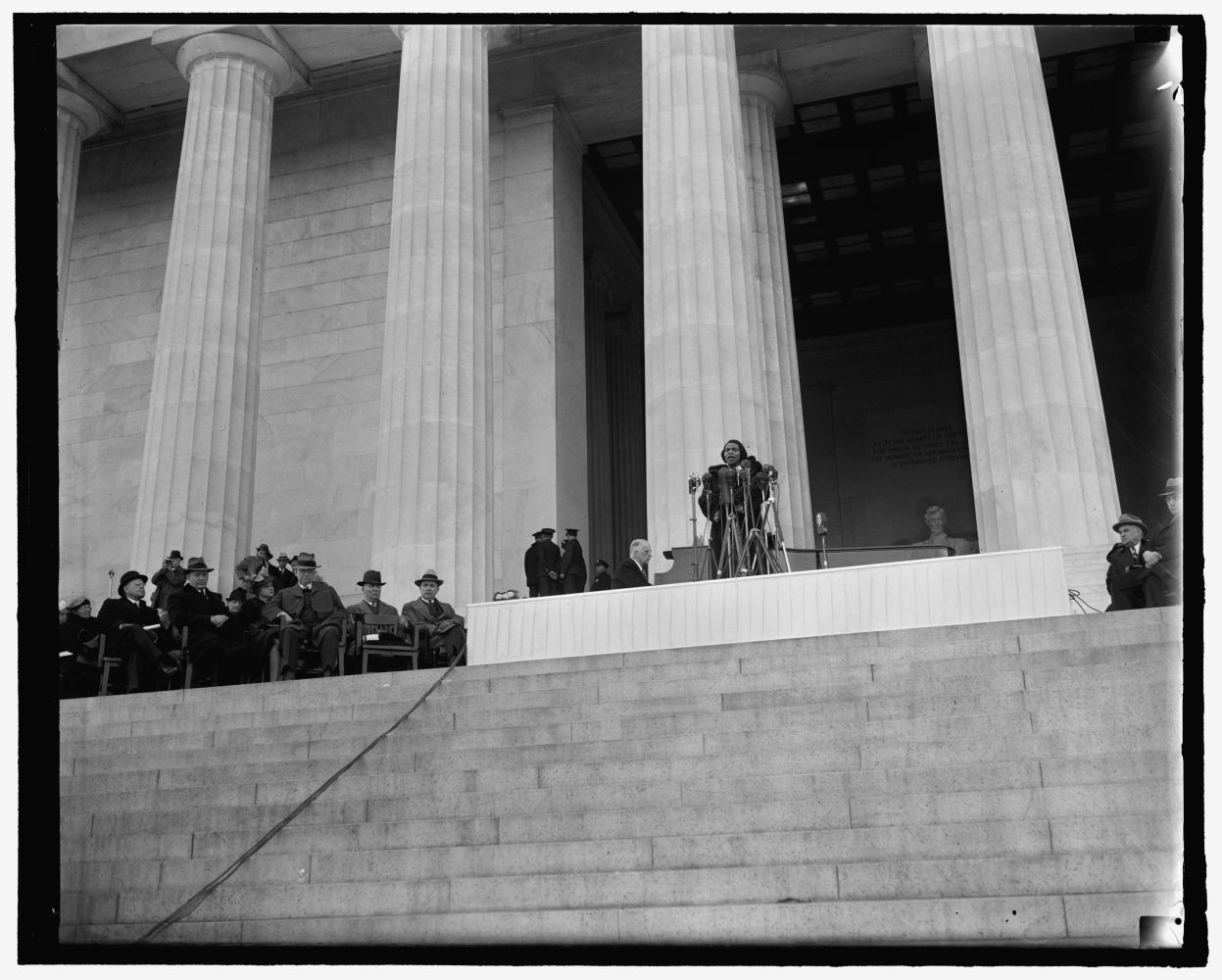 Marian Anderson sings at the Lincoln Memorial with public figures seated nearby.